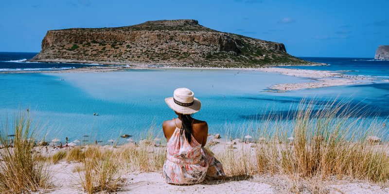 Balos Beach Crete Greece, Balos beach is one of the most beautiful beaches in Greece on the Greek Island, a woman with a hat looking at ocean