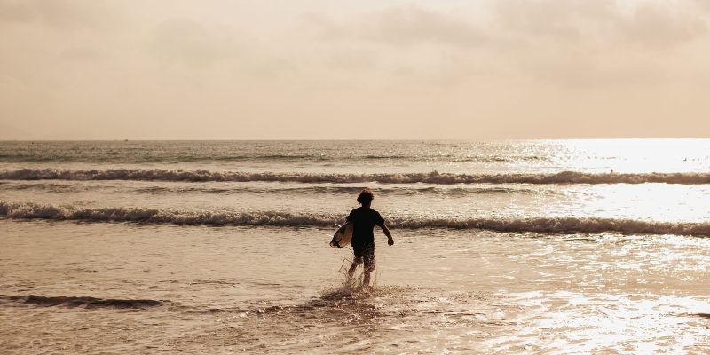 surfer man with sufing board in waves silhouette